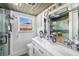 Bright bathroom features a double vanity with modern fixtures and a glass-enclosed shower at 2929 Siesta Dr, Venice, FL 34293