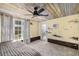Cozy bedroom with hardwood ceiling, ceiling fan, neutral walls, and a large window at 2929 Siesta Dr, Venice, FL 34293