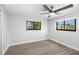 Spacious bedroom with wood flooring, a ceiling fan, and well-lit windows providing plenty of natural light at 2929 Siesta Dr, Venice, FL 34293