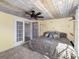 Comfortable bedroom with hardwood ceiling, soft lighting, natural light, and French doors at 2929 Siesta Dr, Venice, FL 34293