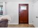 Entryway view with a wood door with glass inset and wood laminate flooring at 2929 Siesta Dr, Venice, FL 34293