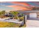 Charming single-story home featuring a lush, meticulously landscaped front yard and one car garage at 2929 Siesta Dr, Venice, FL 34293