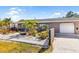Charming home with a manicured, low-maintenance landscaped front yard and an attached garage at 2929 Siesta Dr, Venice, FL 34293