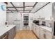 Bright kitchen featuring sleek countertops, stainless steel appliances, and white cabinets at 2929 Siesta Dr, Venice, FL 34293