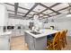 Kitchen island features stainless steel sink, bar seating, and modern lighting fixtures at 2929 Siesta Dr, Venice, FL 34293