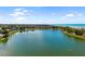 Scenic view of a lake surrounded by lush greenery and a clear blue sky at 2929 Siesta Dr, Venice, FL 34293