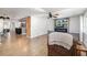 Open-concept living room with wood floors, a ceiling fan, a large flat screen television, and a fire place at 2929 Siesta Dr, Venice, FL 34293