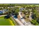 Overhead view of a park area with walking paths, mature trees, a small pond, and parking facilities at 2929 Siesta Dr, Venice, FL 34293