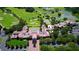 Beautiful aerial view of community, featuring a golf course, lake, and clubhouse at 340 Osprey Point Dr, Osprey, FL 34229