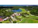 Stunning aerial showcases the golf course community, serene lake, and lush greenery at 340 Osprey Point Dr, Osprey, FL 34229