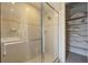 Tiled bathroom with glass shower, tub, and closet at 340 Osprey Point Dr, Osprey, FL 34229