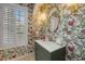Charming powder room with beautiful floral wallpaper and unique fixtures at 340 Osprey Point Dr, Osprey, FL 34229