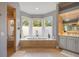 Elegant bathroom features a large tub, walk-in shower, and large windows at 340 Osprey Point Dr, Osprey, FL 34229