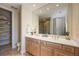 Well-lit bathroom featuring double sinks, wood cabinets, and a shower at 340 Osprey Point Dr, Osprey, FL 34229