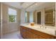 Bathroom with wallpaper, tile flooring, a large vanity and dual sinks at 340 Osprey Point Dr, Osprey, FL 34229