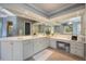 Bright bathroom with double vanity, white countertops, and modern fixtures at 340 Osprey Point Dr, Osprey, FL 34229