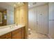 Well-lit bathroom with a single sink vanity, tile flooring, and framed mirror at 340 Osprey Point Dr, Osprey, FL 34229