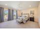Light-filled bedroom with large windows, a patterned bedspread, and stylish decor at 340 Osprey Point Dr, Osprey, FL 34229
