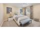 Cozy bedroom featuring neutral decor, patterned curtains, and natural light at 340 Osprey Point Dr, Osprey, FL 34229