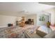 Bright bonus room with whitewashed floors, a vaulted ceiling, and a comfortable seating area at 340 Osprey Point Dr, Osprey, FL 34229
