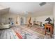 Spacious bonus room with whitewashed floors, a vaulted ceiling, and a colorful rug at 340 Osprey Point Dr, Osprey, FL 34229