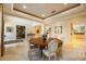 Bright dining room features a round table, six chairs, and elegant decor at 340 Osprey Point Dr, Osprey, FL 34229