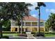 Elegant two-story building with charming details, lush landscaping and a welcoming entrance at 340 Osprey Point Dr, Osprey, FL 34229