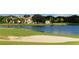 Picturesque golf course view with a sand trap, lake, and elegant homes in a beautiful community at 340 Osprey Point Dr, Osprey, FL 34229