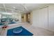 Home gym with mirrored walls, multiple storage cabinets, and fitness accessories at 340 Osprey Point Dr, Osprey, FL 34229