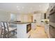 Open kitchen layout with island seating, built-in microwave, and stainless steel appliances at 340 Osprey Point Dr, Osprey, FL 34229