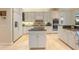 Well-lit kitchen featuring white cabinets, stainless steel appliances, and a functional island at 340 Osprey Point Dr, Osprey, FL 34229