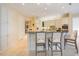 Bright kitchen with white cabinetry, stainless steel appliances, granite countertops, and bar seating at 340 Osprey Point Dr, Osprey, FL 34229
