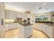 Spacious kitchen featuring granite counters, island seating, pendant lighting, and modern appliances at 340 Osprey Point Dr, Osprey, FL 34229