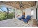 Covered outdoor lanai featuring blue chaise lounges, ceiling fan, and privacy screens at 340 Osprey Point Dr, Osprey, FL 34229