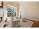 Bright and airy living room with a fireplace, curved window, and modern decor at 340 Osprey Point Dr, Osprey, FL 34229