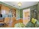 Cozy office with hardwood floors, built-in shelves, and unique wallpaper at 340 Osprey Point Dr, Osprey, FL 34229