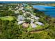 Aerial view of the home on a golf course, lush greenery, and lake views at 355 Melrose Ct, Venice, FL 34292
