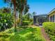 A tranquil outdoor setting with a screened-in lanai and lush greenery surrounding the property at 355 Melrose Ct, Venice, FL 34292