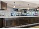 Bar with dark wood finishes, marble countertop, mirrored wall, and overhead pendant lights at 355 Melrose Ct, Venice, FL 34292