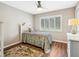 Bright bedroom with hardwood floors, plantation shutters, and coastal decor at 355 Melrose Ct, Venice, FL 34292