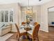 Bright dining area featuring a glass table, wicker chairs, and contemporary lighting, perfect for entertaining at 355 Melrose Ct, Venice, FL 34292