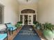 Welcoming entrance to the Venice Golf and Country Club with seating and lush potted plants at 355 Melrose Ct, Venice, FL 34292