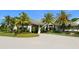 Inviting entrance with lush landscaping, a circular driveway, and a porte-cochere entrance providing curb appeal at 355 Melrose Ct, Venice, FL 34292