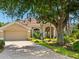 Single-story home with a tile roof, paver driveway, and mature landscaping at 355 Melrose Ct, Venice, FL 34292