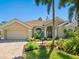 Single-story home with a tile roof, paver driveway, and mature landscaping at 355 Melrose Ct, Venice, FL 34292