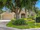 Charming single-story home with a beautiful landscape, mature trees, and a well-manicured lawn at 355 Melrose Ct, Venice, FL 34292