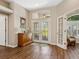 Welcoming foyer features double glass doors, wood floors, and classic decor at 355 Melrose Ct, Venice, FL 34292