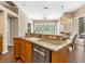 Bright kitchen featuring granite countertops and wooden cabinets, with views of dining area at 355 Melrose Ct, Venice, FL 34292