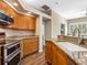 Updated kitchen featuring granite countertops, stainless appliances, and wooden cabinets at 355 Melrose Ct, Venice, FL 34292