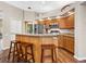 Well-appointed kitchen featuring a granite island, wooden cabinets, and modern stainless steel appliances at 355 Melrose Ct, Venice, FL 34292